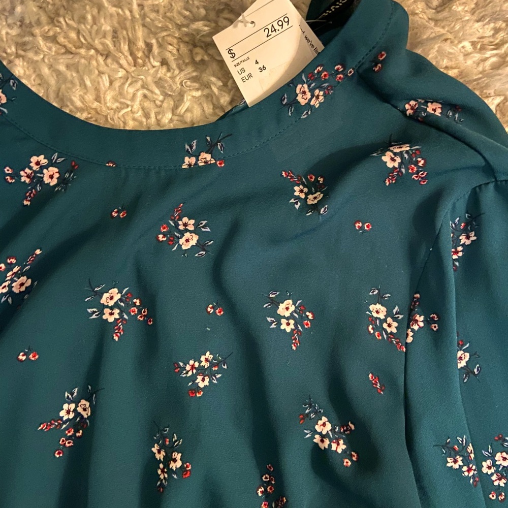 Dark green/teal blouse with floral design